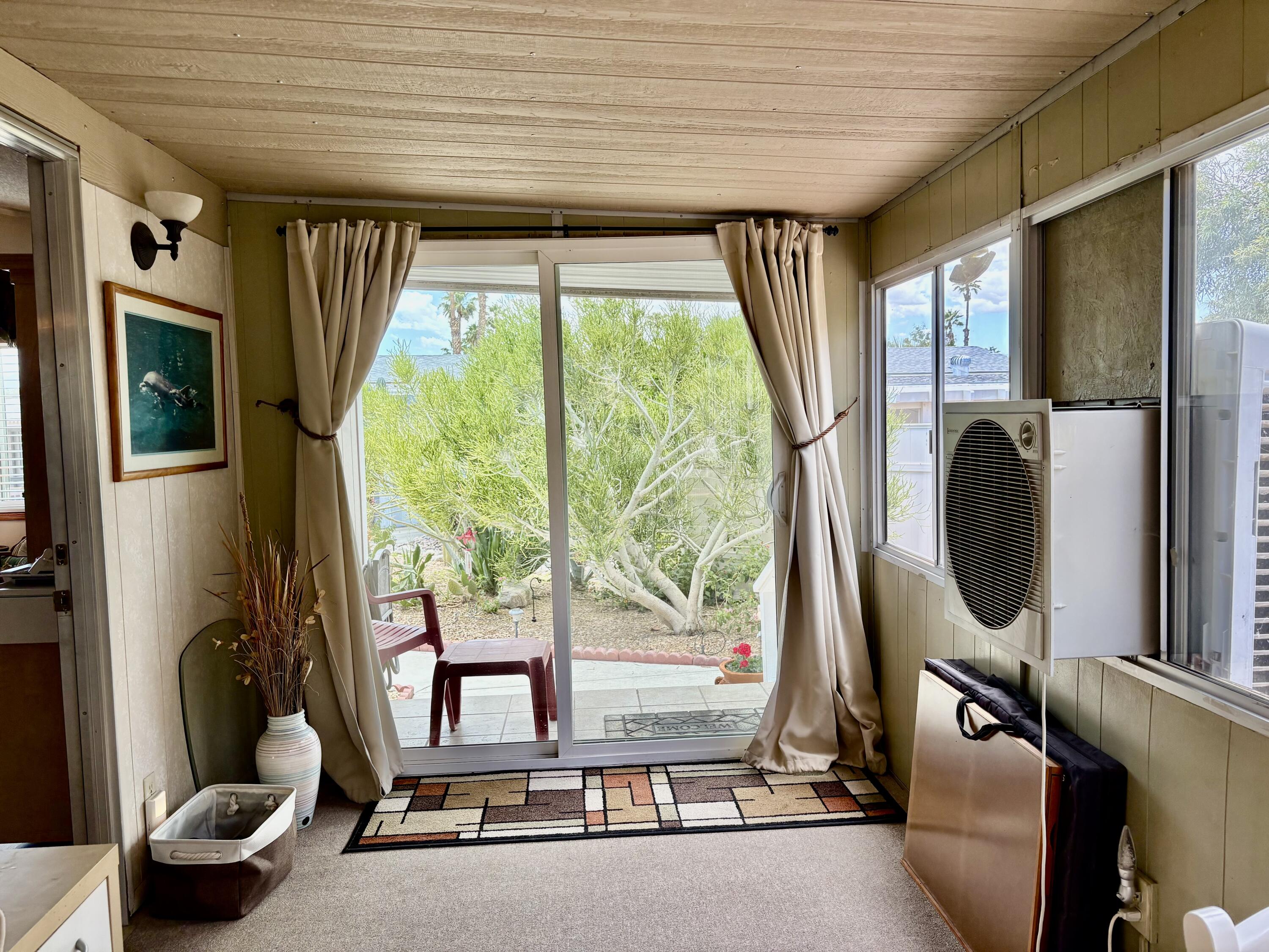 74711 Dillon Road, Unit 635 Desert Hot Springs, CA 92241 - Photo 22 of 55 a room with large windows and furniture