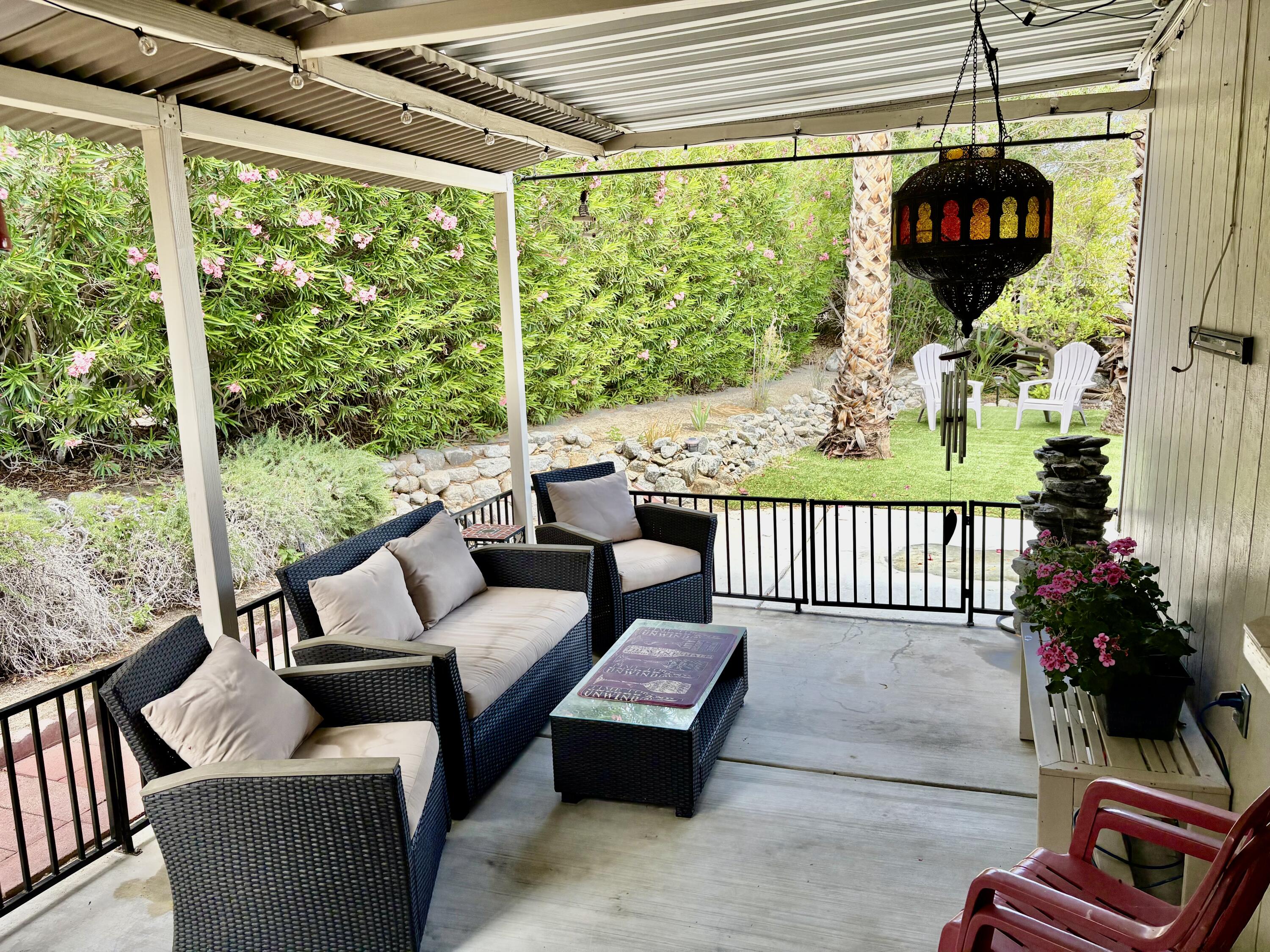 74711 Dillon Road, Unit 635 Desert Hot Springs, CA 92241 - Photo 23 of 55 a outdoor living space with furniture and garden view