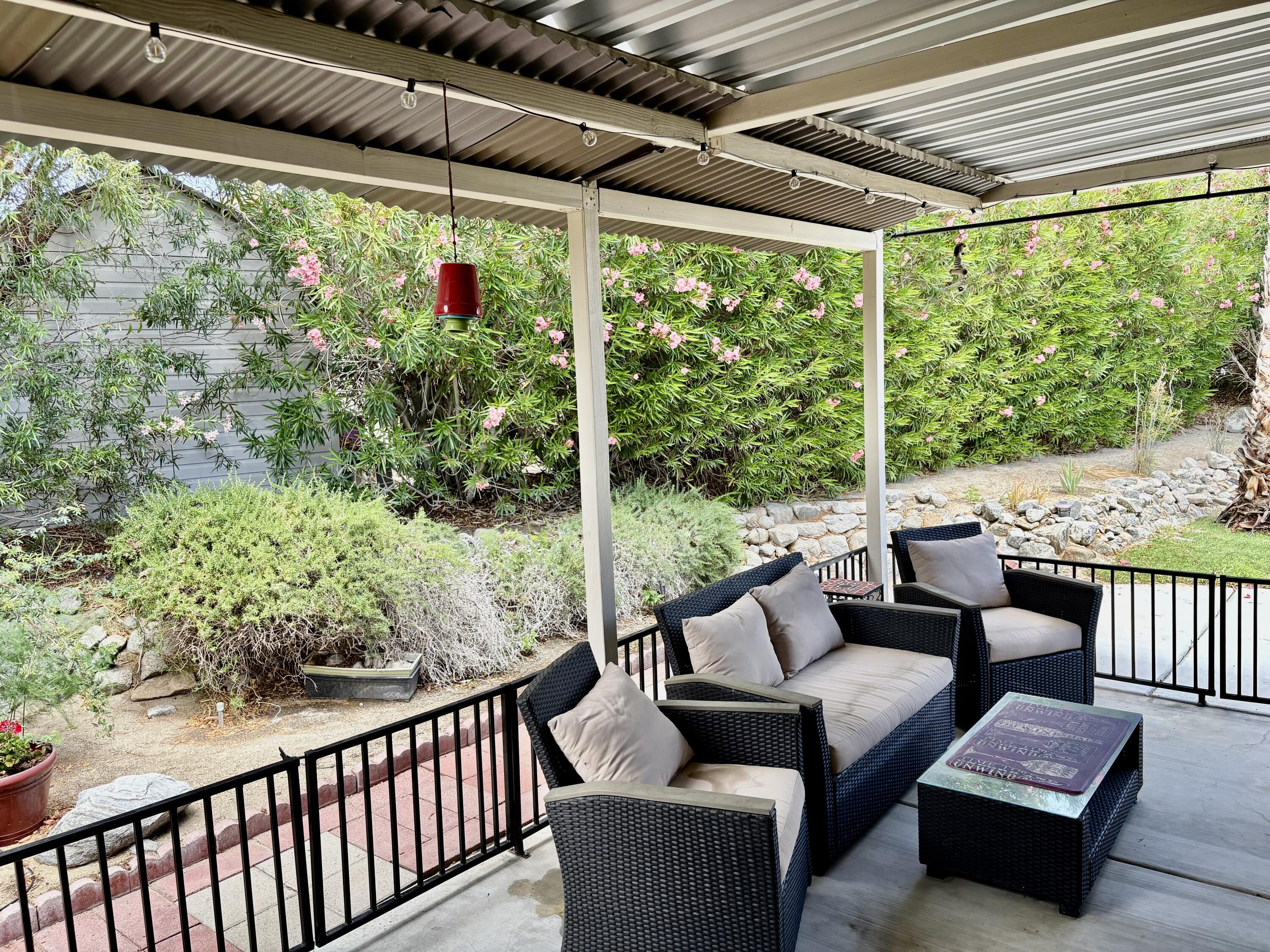 74711 Dillon Road, Unit 635 Desert Hot Springs, CA 92241 - Photo 24 of 55 a outdoor living space with furniture and garden view
