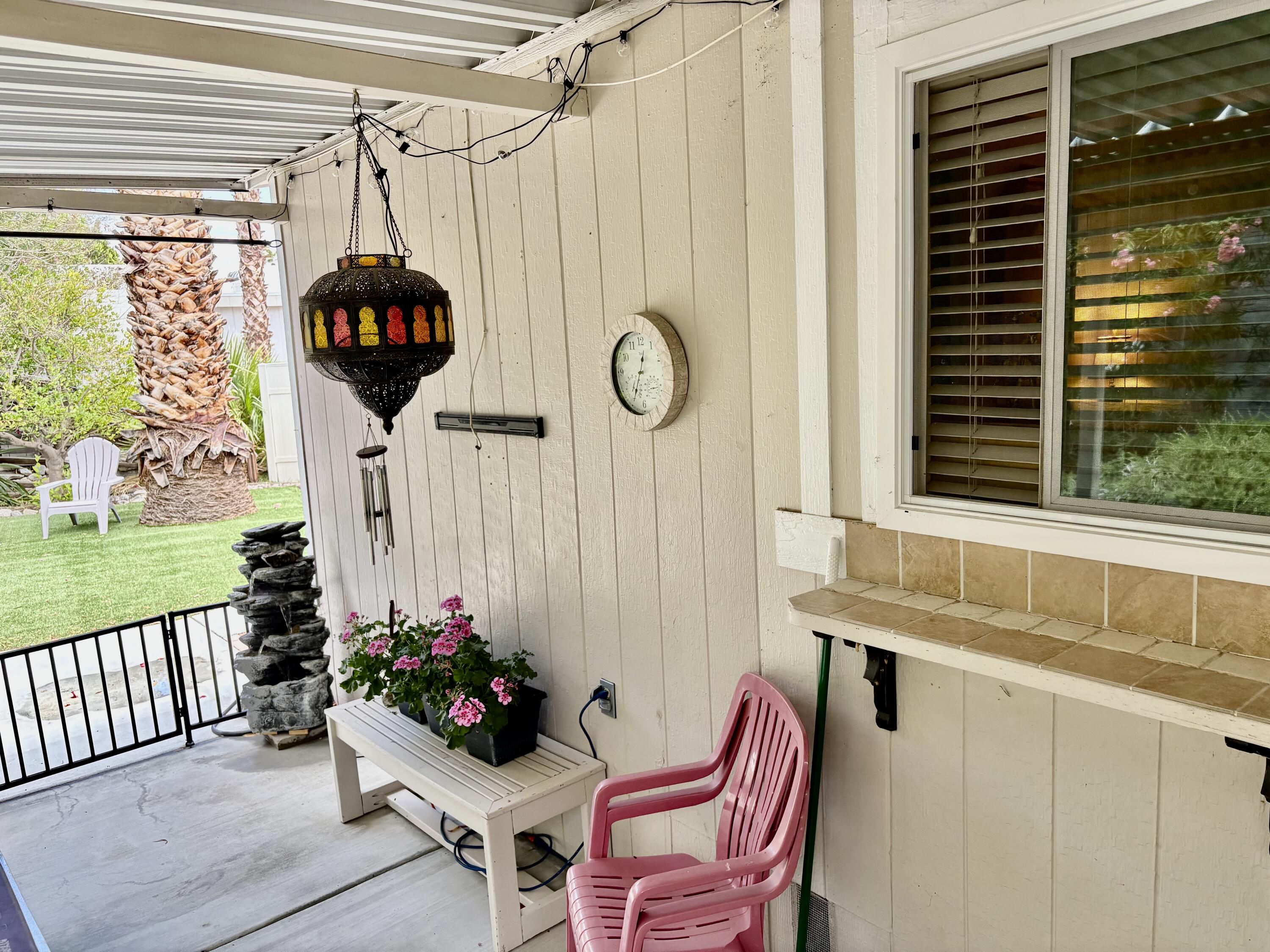 74711 Dillon Road, Unit 635 Desert Hot Springs, CA 92241 - Photo 26 of 55 a table and a vase of flowers sitting on a table with window