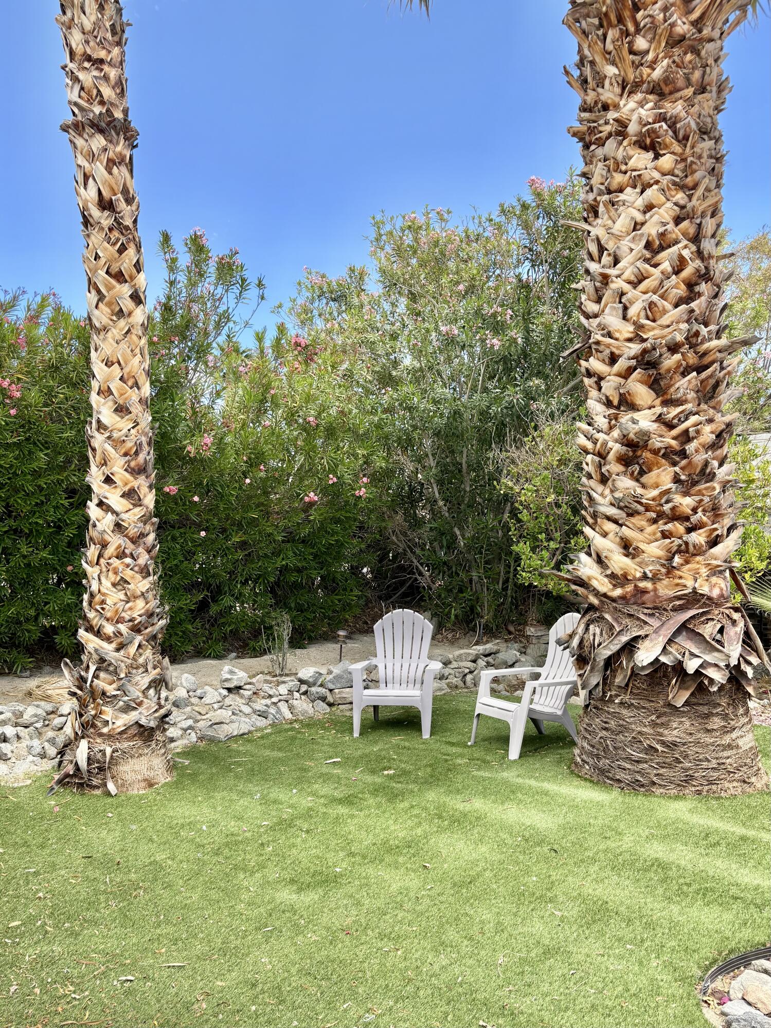 74711 Dillon Road, Unit 635 Desert Hot Springs, CA 92241 - Photo 28 of 55 a backyard of a house with table and chairs