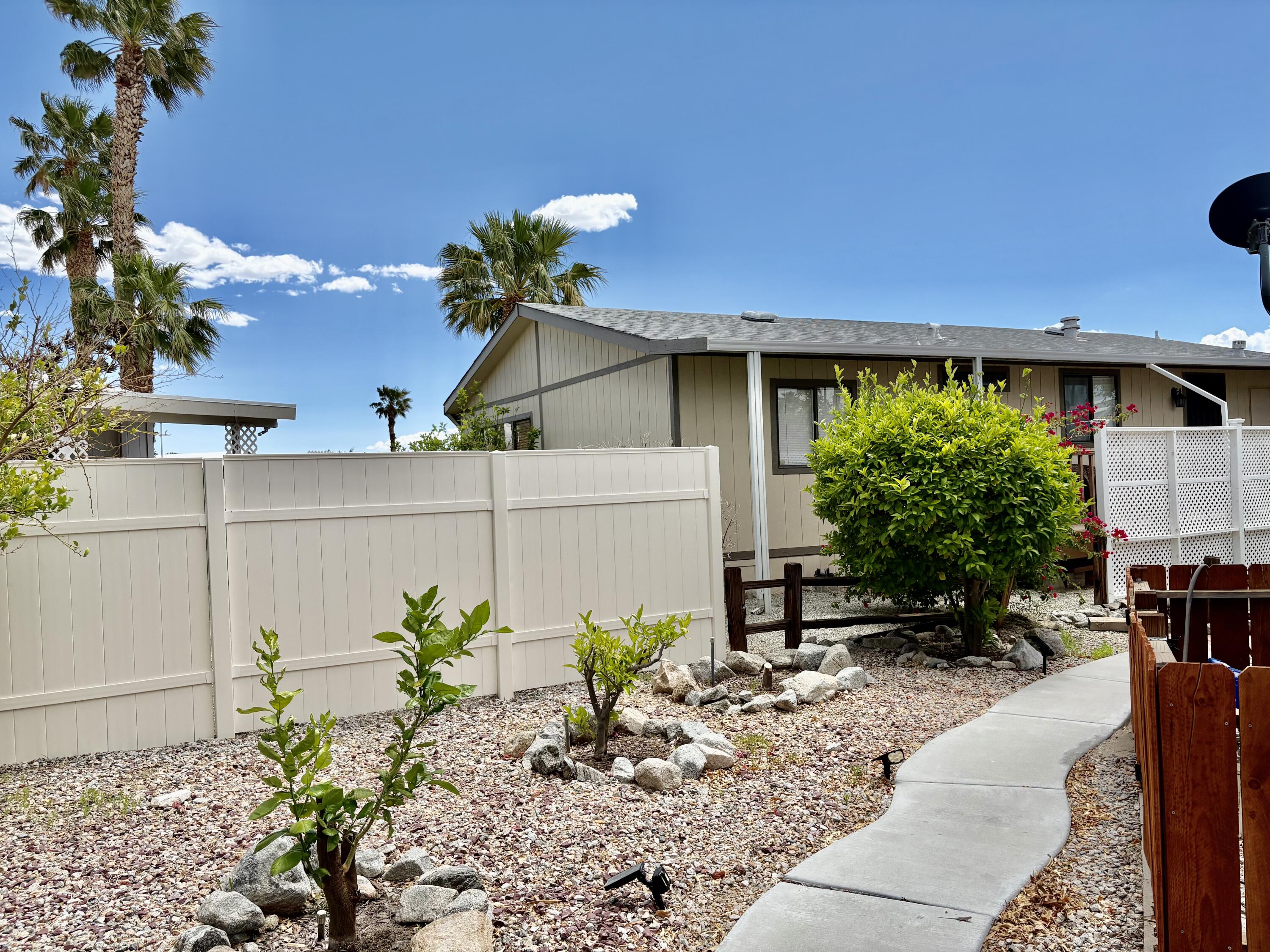74711 Dillon Road, Unit 635 Desert Hot Springs, CA 92241 - Photo 30 of 55 a front view of a house with a yard