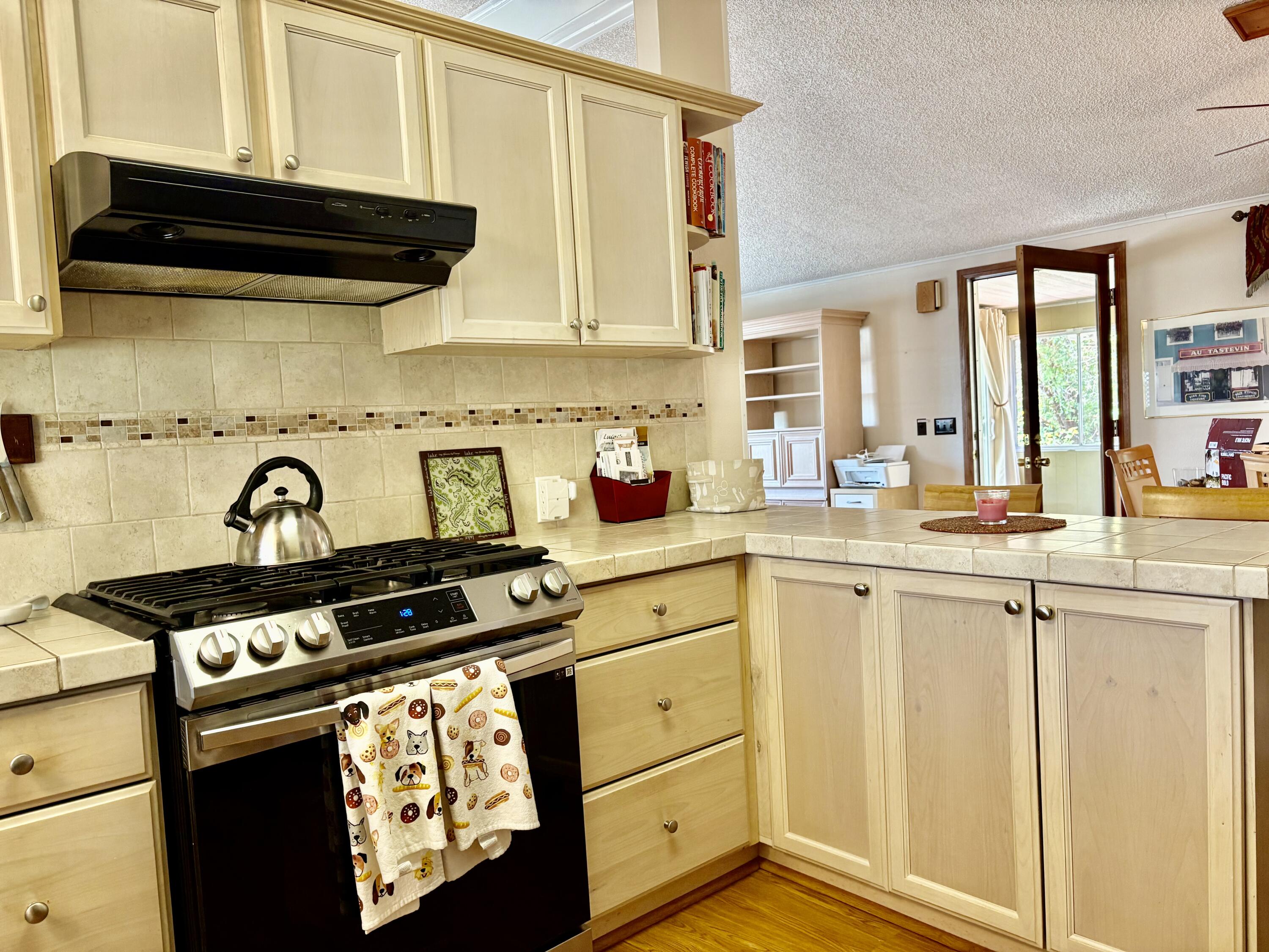 74711 Dillon Road, Unit 635 Desert Hot Springs, CA 92241 - Photo 9 of 55 a kitchen with stainless steel appliances granite countertop a stove and a microwave