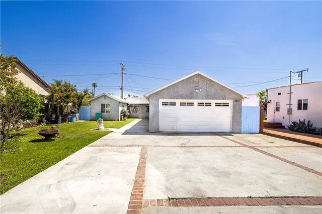 a view of a house with a yard and garage