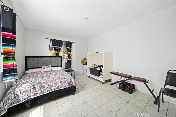 a bedroom with bed and a window