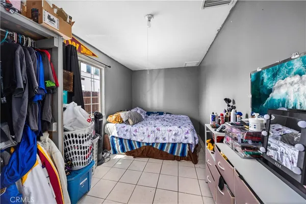 a bedroom with furniture and a flat screen tv