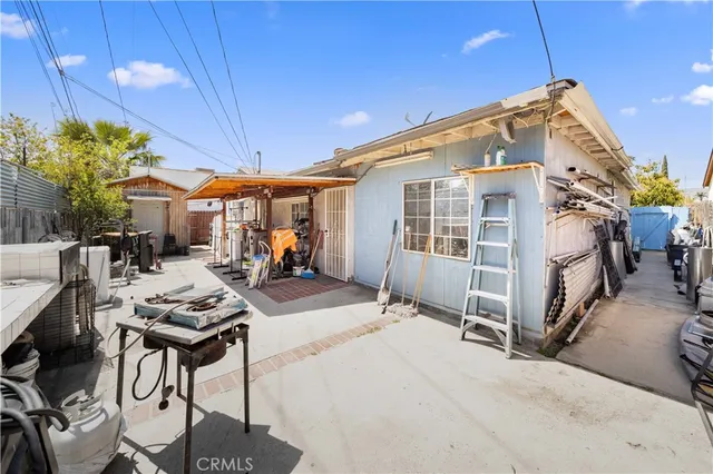 a view of a patio with table and chairs under an umbrella