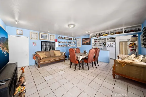 a living room with furniture a table and a bookshelf