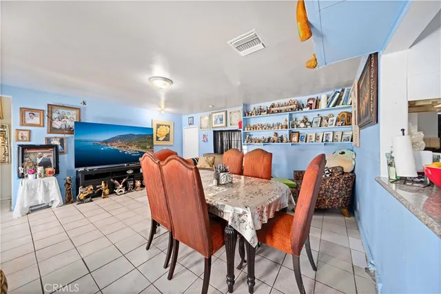 a dining room with furniture and a flat screen tv