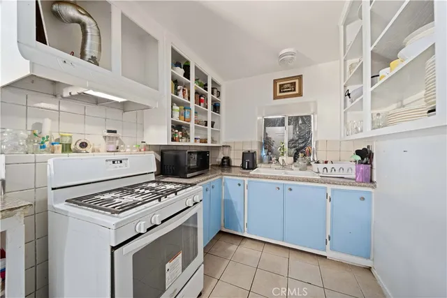 a kitchen with stainless steel appliances a white stove top oven and a refrigerator