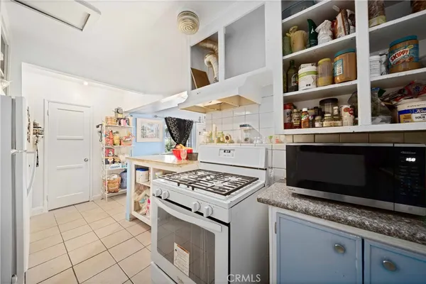 a kitchen with stainless steel appliances granite countertop a stove and a cabinets