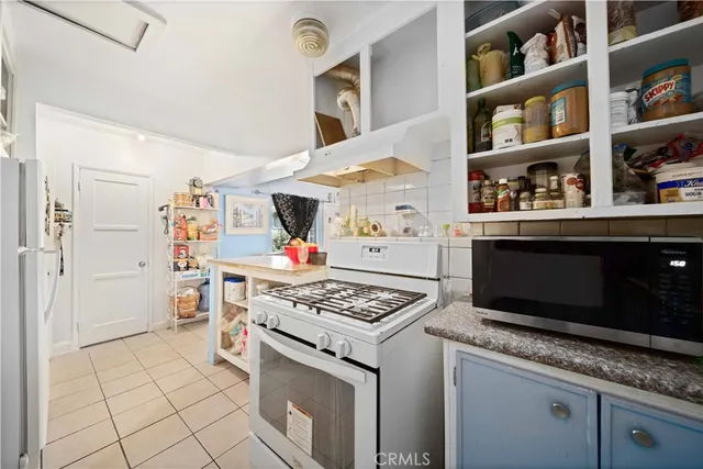 a kitchen with stainless steel appliances granite countertop a stove and a cabinets