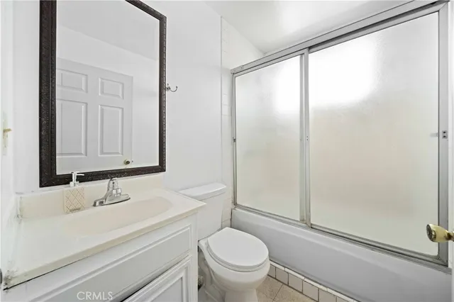 a bathroom with a sink a mirror and a toilet