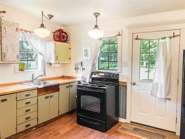 a kitchen with a stove and a window