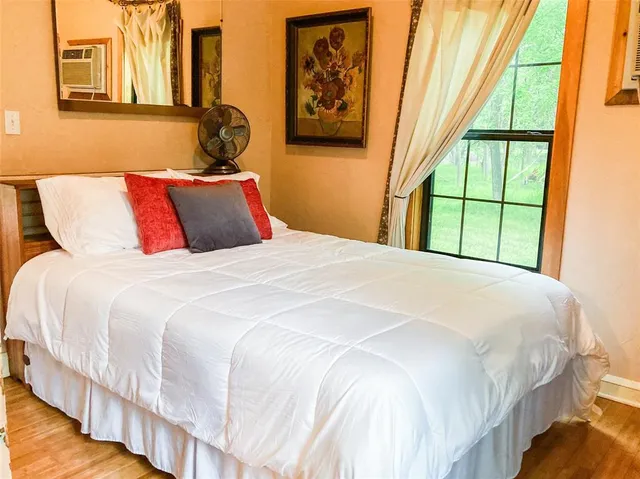 a bedroom with a bed and a window