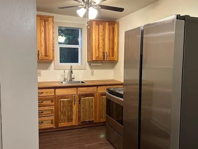 a kitchen with stainless steel appliances granite countertop a refrigerator and a sink
