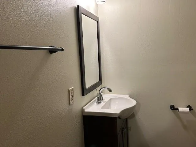 a bathroom with a sink and mirror