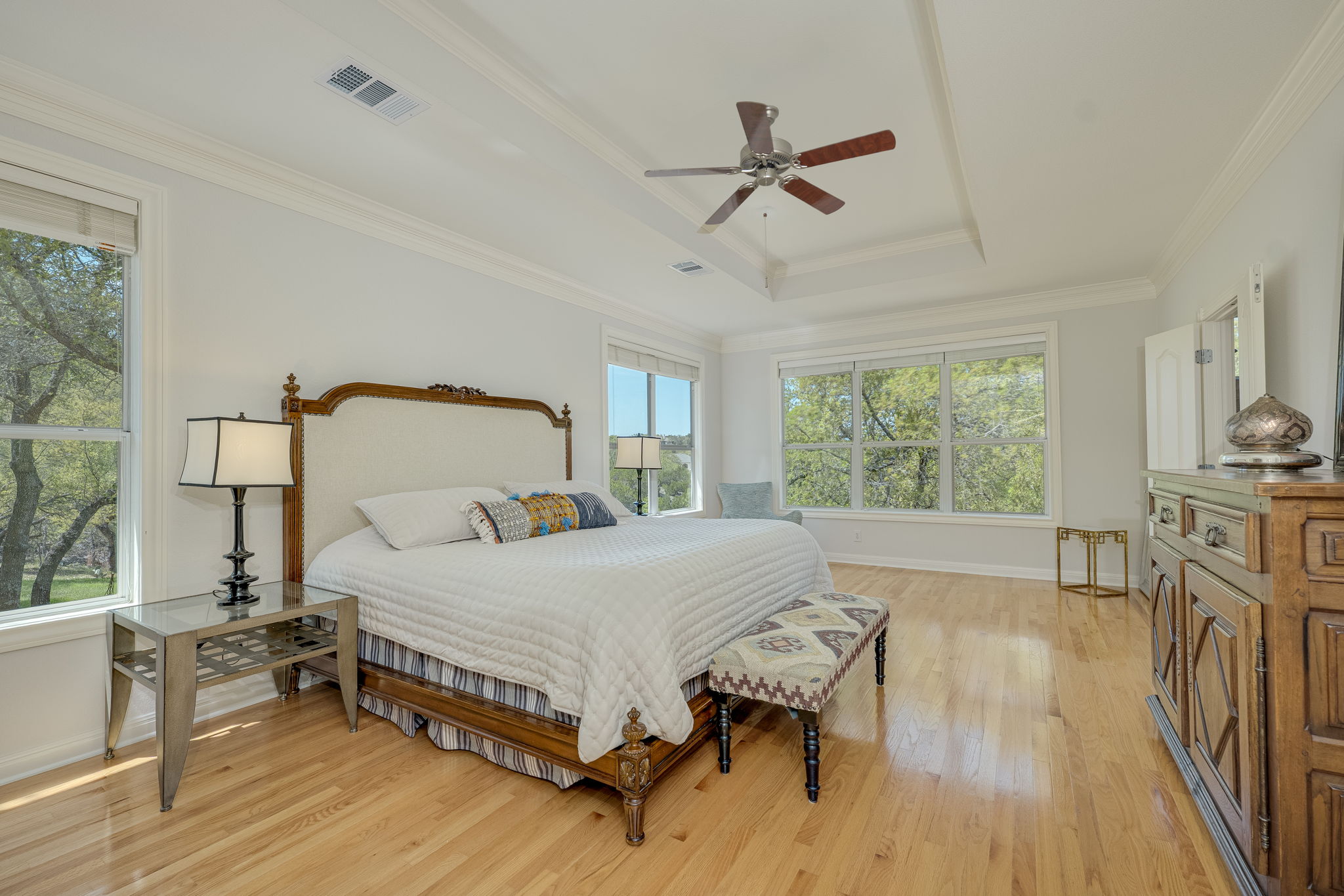 4424 Lago Viento Austin, TX 78734 - Photo 18 of 38 The primary bedroom suite is the perfect place to unwind. This room is located on the back of the home and has beautiful views of the hills and trees.