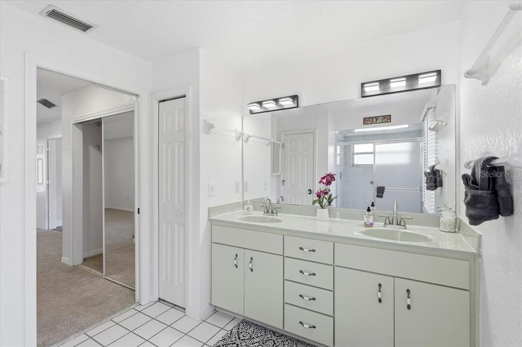 30 Patuxent Lane Palm Coast, FL 32164 - Photo 16 of 34 a bathroom with a granite countertop sink mirror and shower
