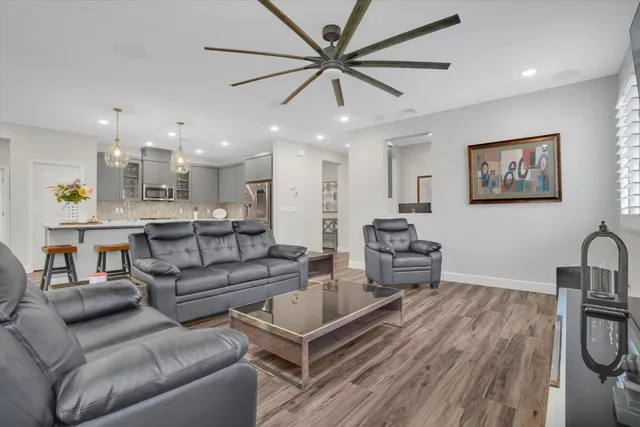 a living room with furniture and kitchen view