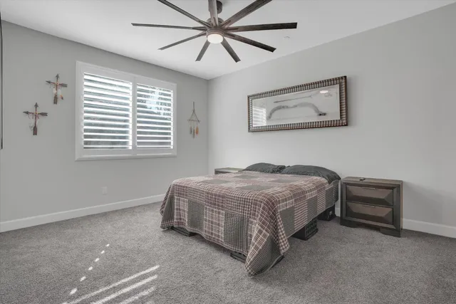 a bedroom with a bed and a chandelier