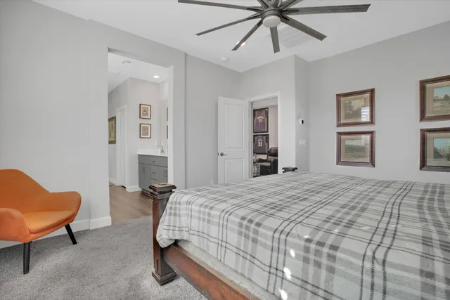 a bedroom with a bed a couch and dresser