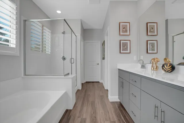 a bathroom with a bathtub a sink and a window