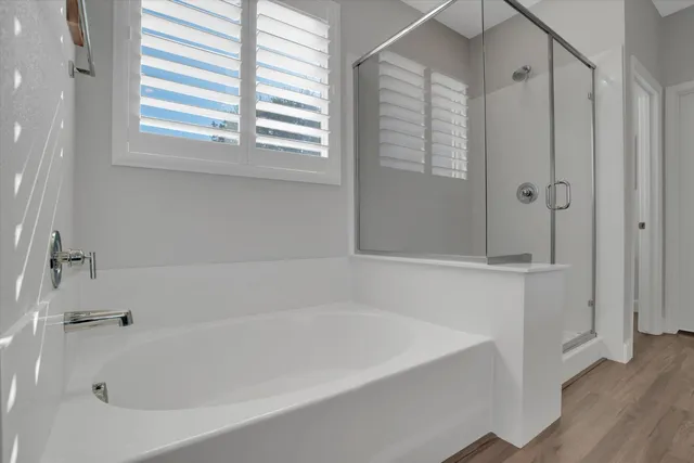 a bathroom with bathtub and shower
