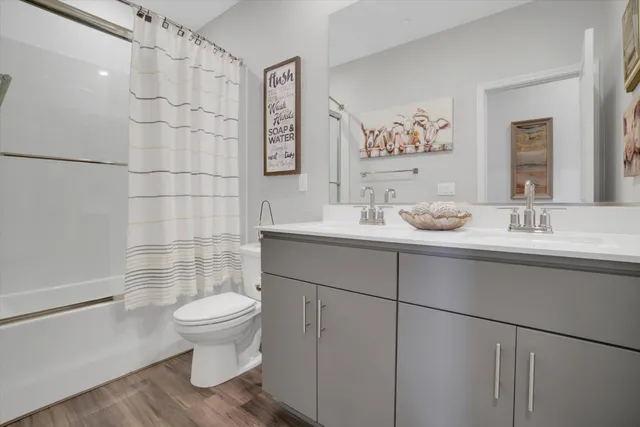 a bathroom with a sink toilet and shower