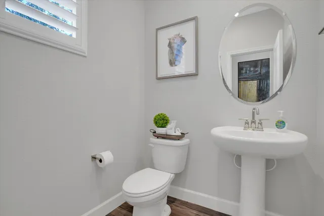 a bathroom with a toilet sink and mirror