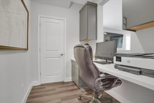 a view of workspace with wooden floor windows