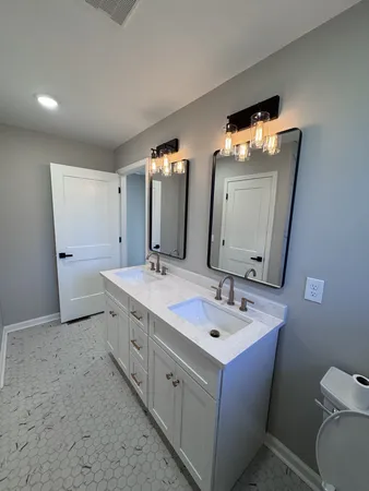 a bathroom with a double vanity sink and a mirror