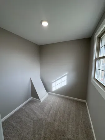a view of workspace with window and stairs