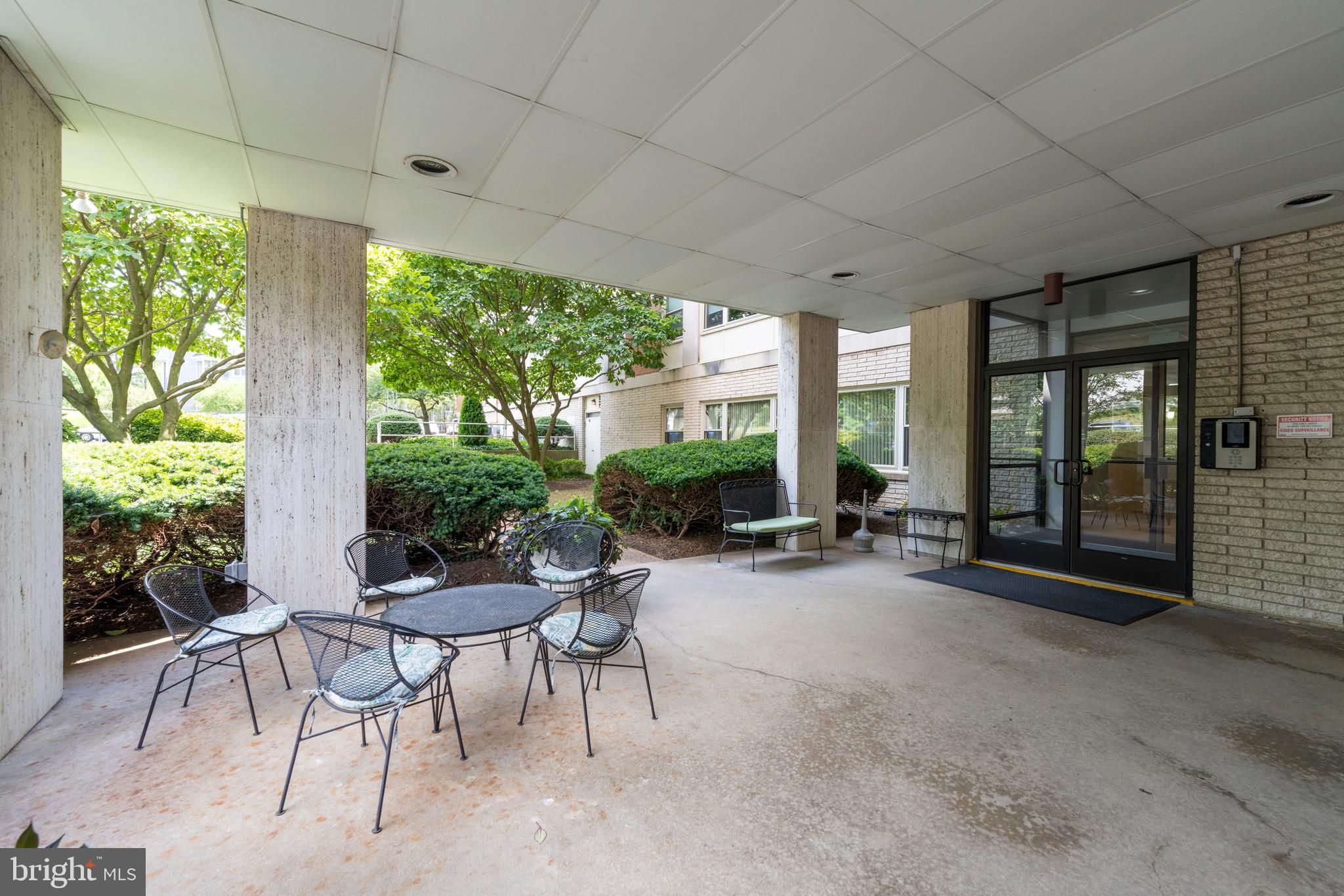 4401 Roland Avenue, Unit 115 Baltimore, MD 21210 - Photo 13 of 54 a view of a patio with chairs and floor to ceiling window