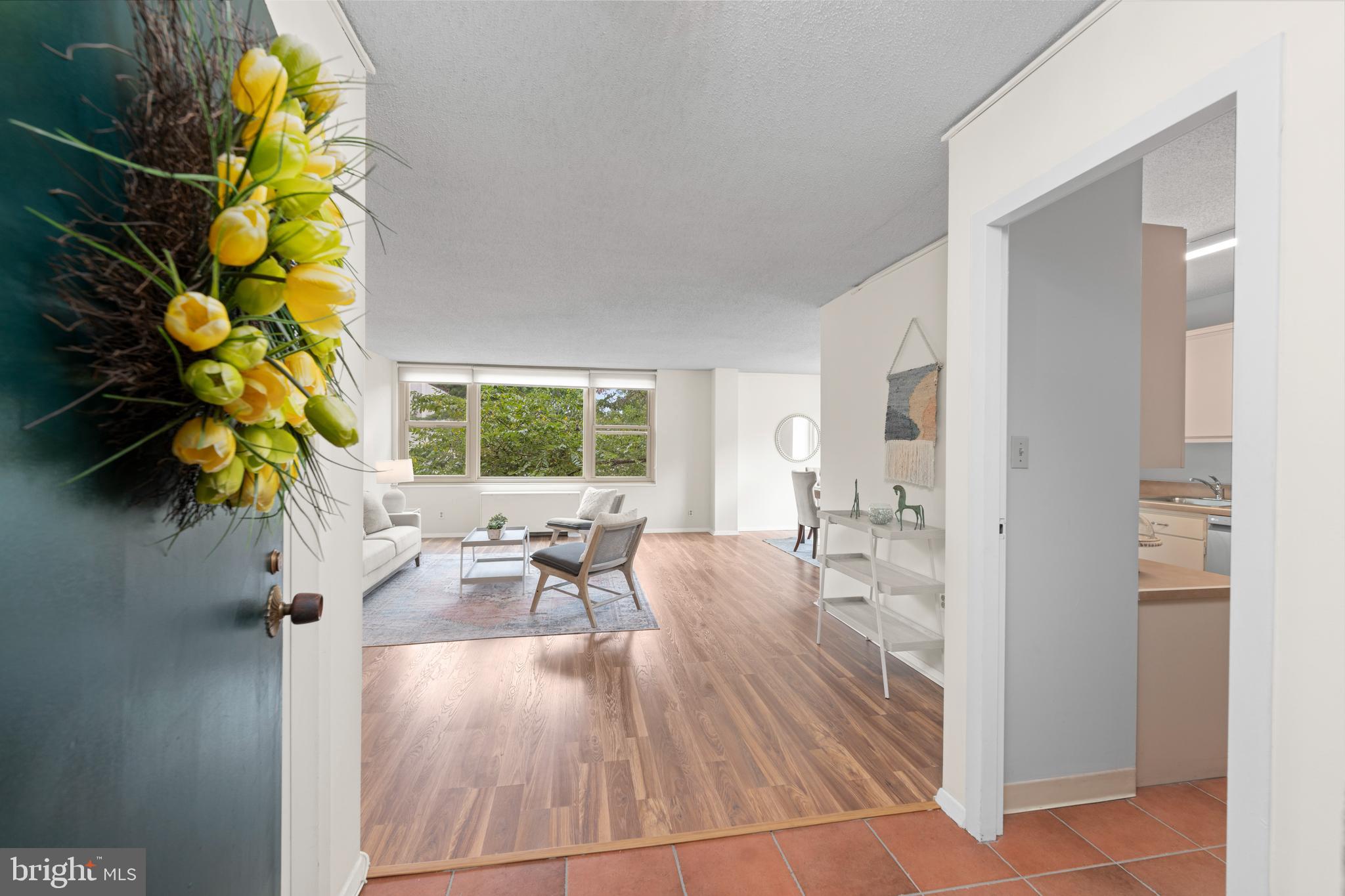 4401 Roland Avenue, Unit 115 Baltimore, MD 21210 - Photo 15 of 54 a living room with furniture and a large window