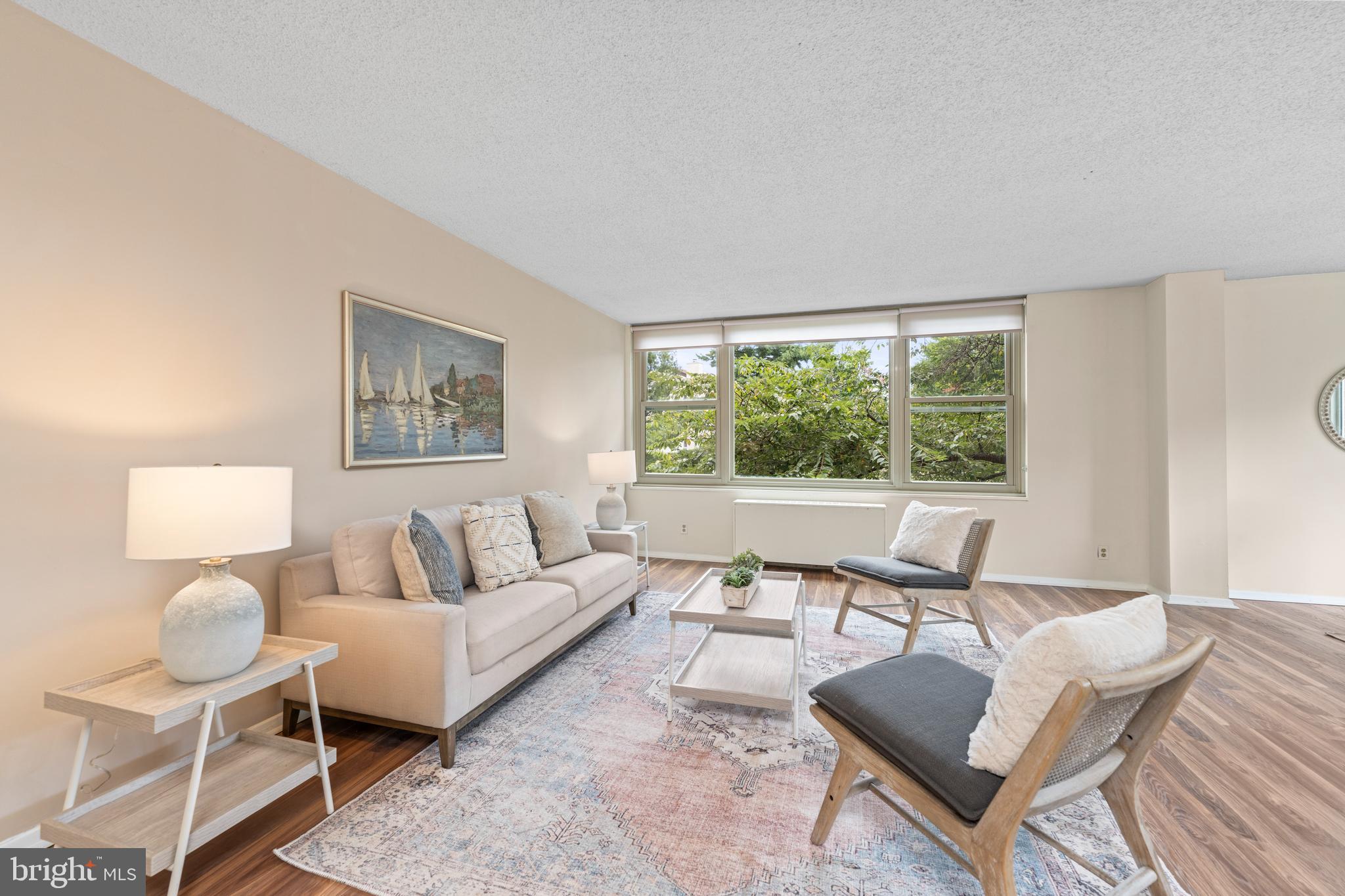 4401 Roland Avenue, Unit 115 Baltimore, MD 21210 - Photo 16 of 54 a living room with furniture and a large window