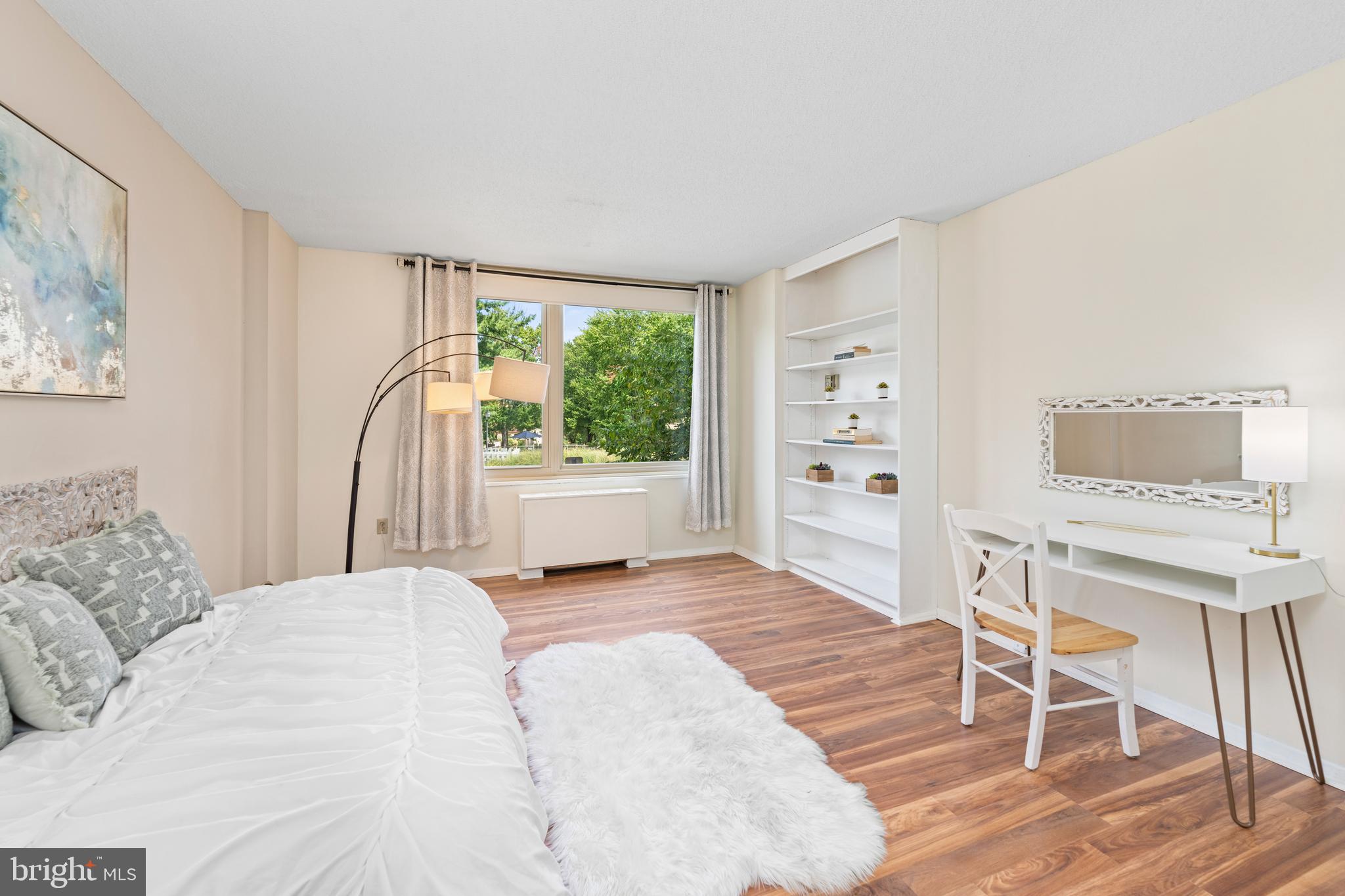 4401 Roland Avenue, Unit 115 Baltimore, MD 21210 - Photo 37 of 54 a bedroom with a bed and a table in it