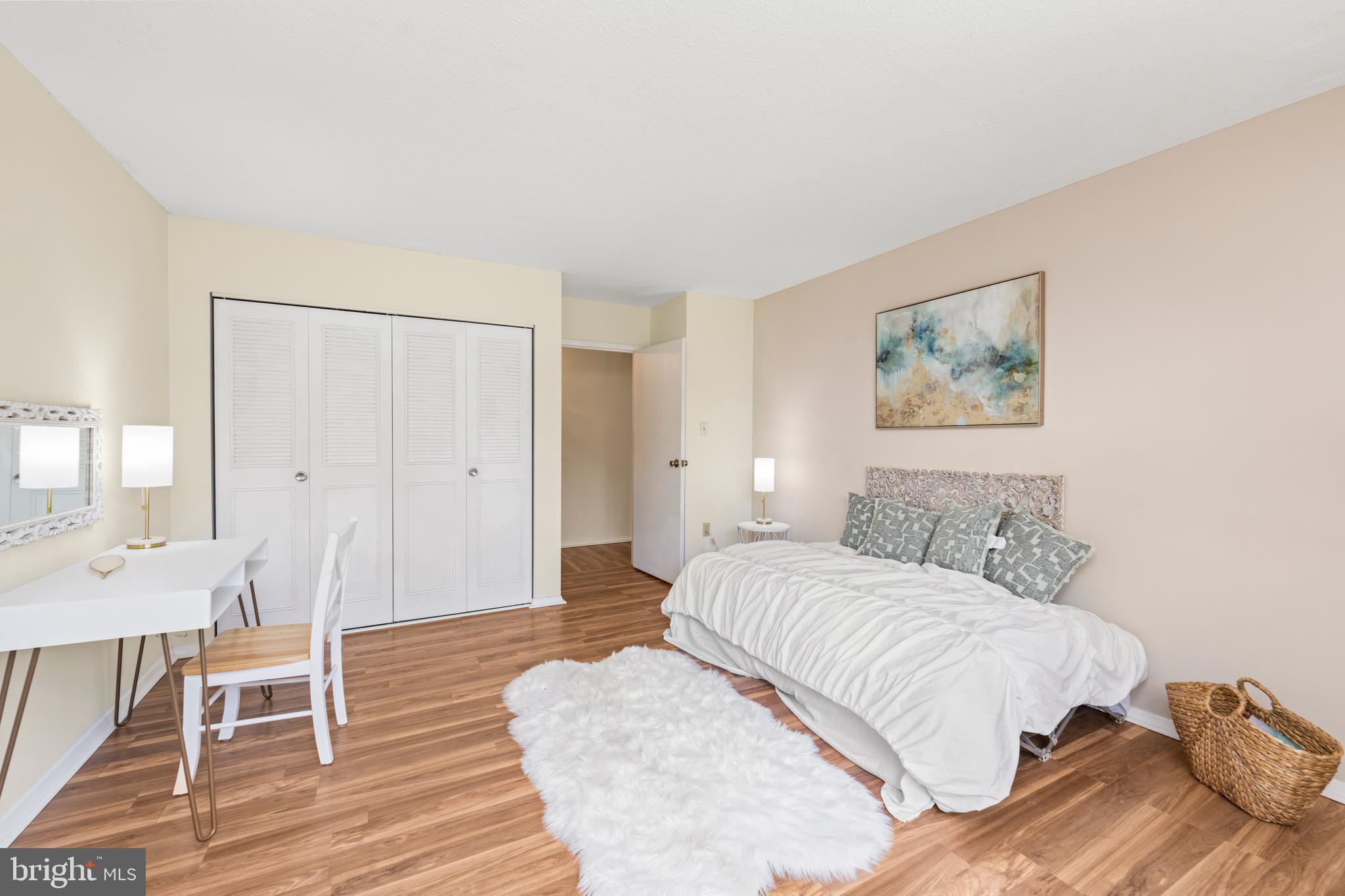 4401 Roland Avenue, Unit 115 Baltimore, MD 21210 - Photo 39 of 54 a bedroom with a bed and a table