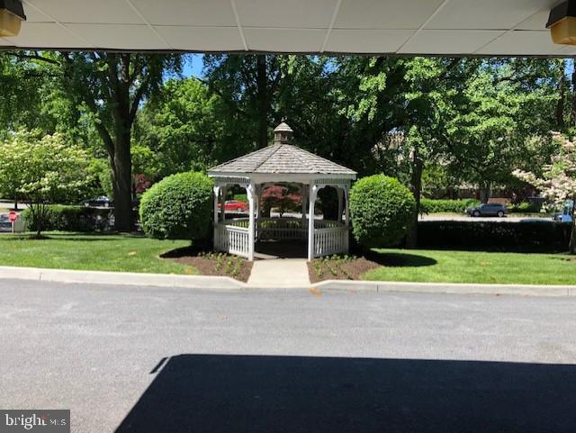 4401 Roland Avenue, Unit 115 Baltimore, MD 21210 - Photo 4 of 54 a view of a house with a yard and sitting area