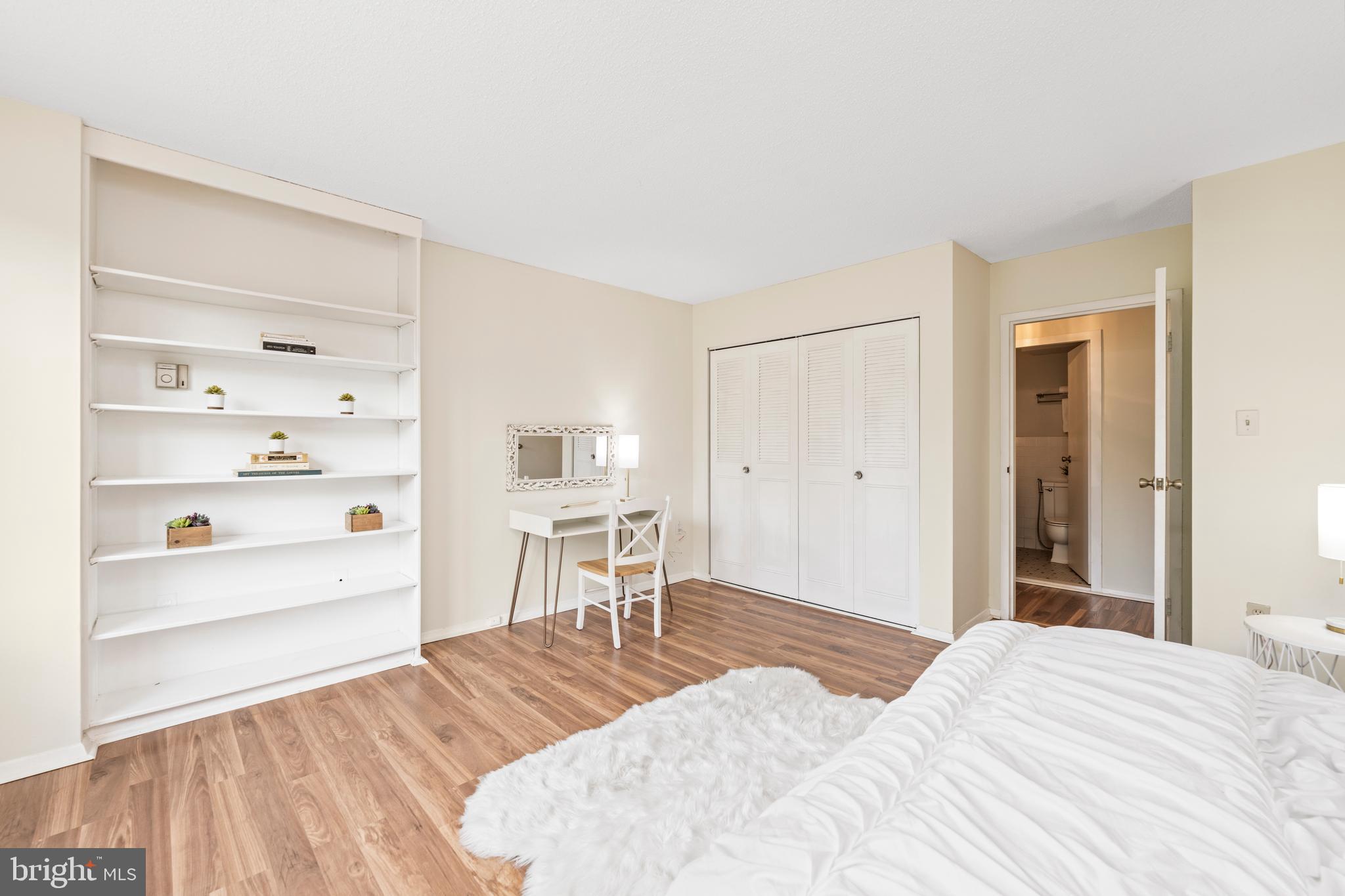 4401 Roland Avenue, Unit 115 Baltimore, MD 21210 - Photo 43 of 54 a bedroom with a bed and a cabinets