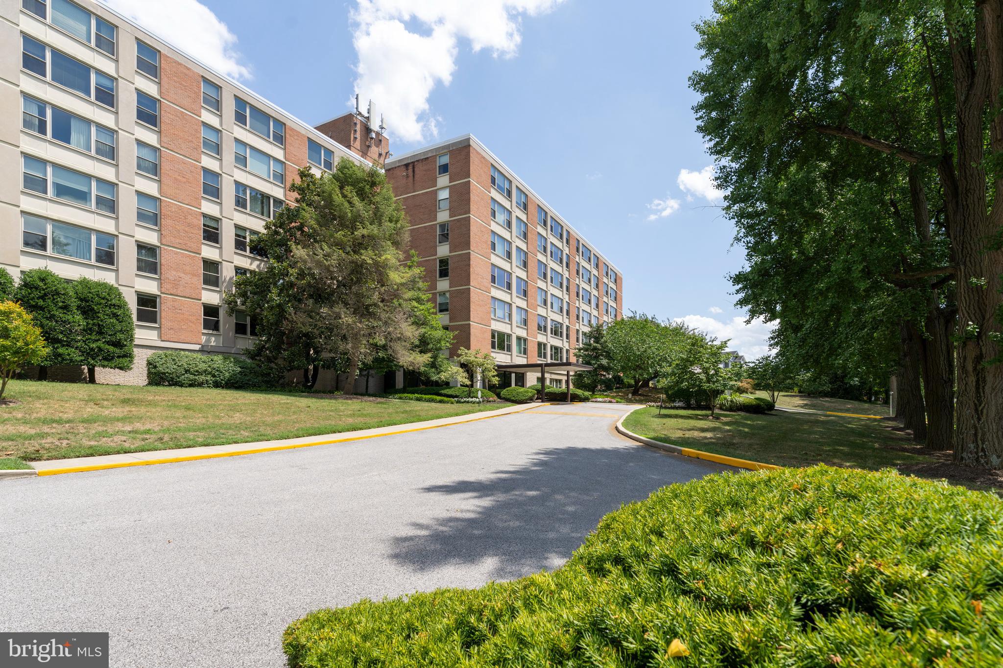 4401 Roland Avenue, Unit 115 Baltimore, MD 21210 - Photo 54 of 54 a view of a tall building next to a yard