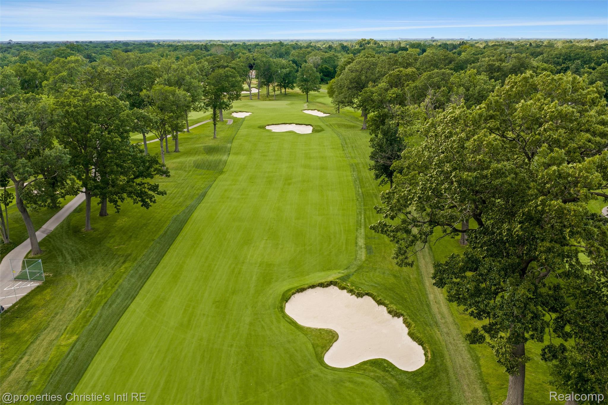 2771 West Seven Mile Road Detroit, MI 48221 - Photo 55 of 57 Expansive golf course fairway featuring meticulously maintained turf, strategically placed sand bunkers, mature trees lining the course, and a paved cart path