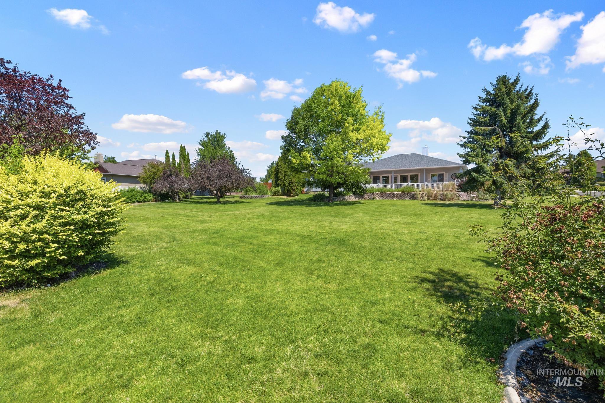 15181 Drury Way Caldwell, ID 83607 - Photo 40 of 49 Expansive green lawn framed by mature trees and shrubs