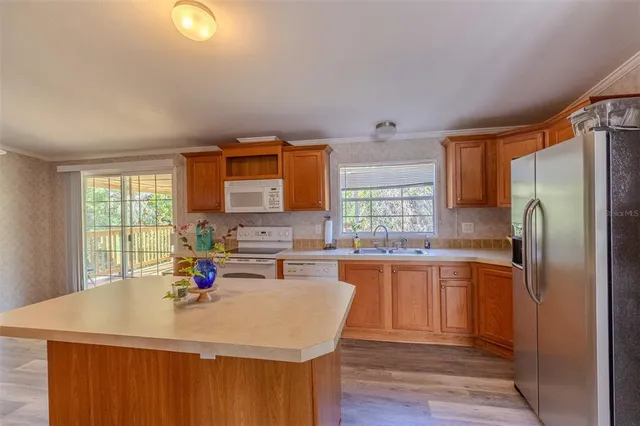 a kitchen with stainless steel appliances a sink stove and refrigerator