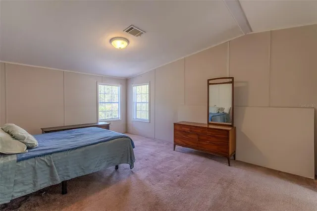 a bedroom with a bed and window