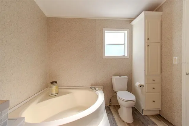 a white toilet sitting next to a bathroom sink