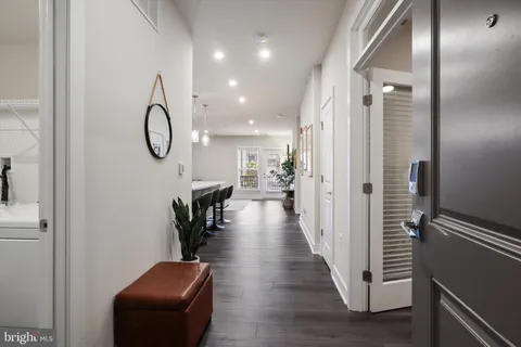 a view of a hallway with wooden floor and glass door