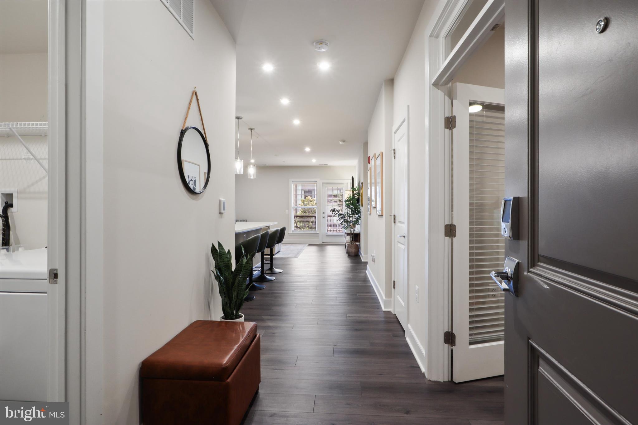a view of a hallway with wooden floor and glass door