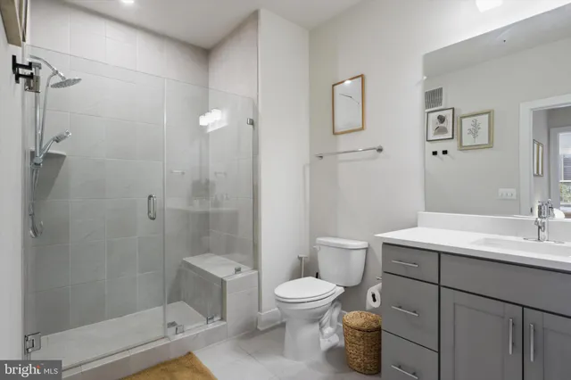 a bathroom with a toilet sink and shower