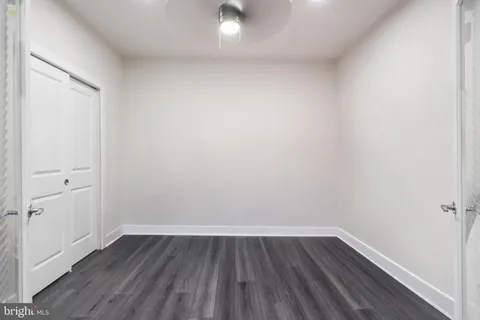 a view of a small space with wooden floor and a window